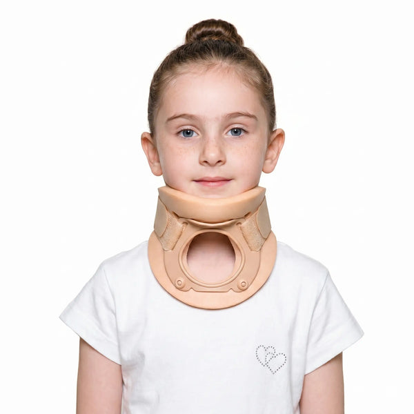 Young girl wearing a beige neck brace on a white background