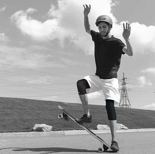 Neon orange Air knee cap shown in use for joint support during sports and physical activities