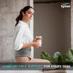 Woman wearing a back brace holding a coffee cup with 'tynor' branding and text about comfortable support.