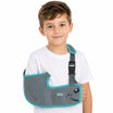 Child wearing a gray and teal sling with 'tynor' branding on a white background