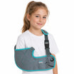 Child wearing a gray and teal sling with a shark design on a white background