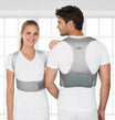 Two people wearing gray posture correctors with 'tynor' branding.